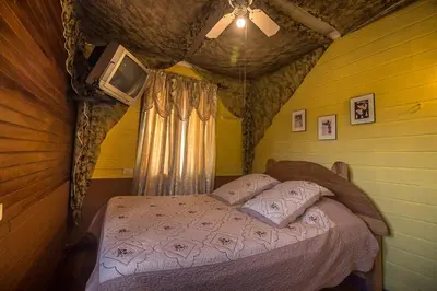 a bedroom with a bed in a tree house at Casa Antigua Hotel in Alajuela City