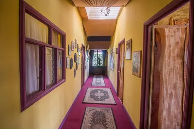 a hallway with colorful carpets on the floors of a house at Casa Antigua Hotel in Alajuela City