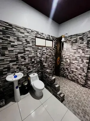 a bathroom with a toilet and a sink at Teyú Green Cottage in Cuatro Esquinas