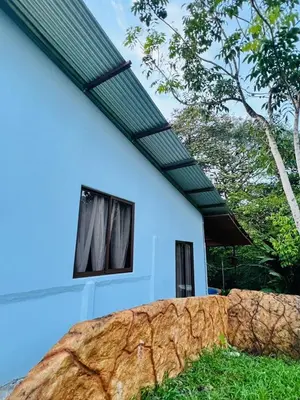 a white house with a roof with windows at Teyú Green Cottage in Cuatro Esquinas