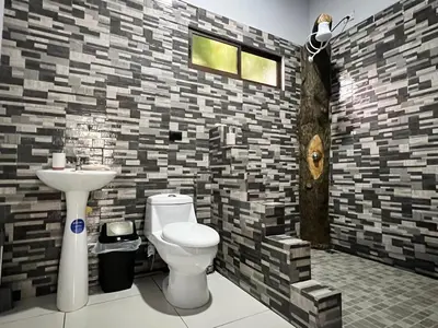 a bathroom with a toilet and a sink at Teyú Green Cottage in Cuatro Esquinas
