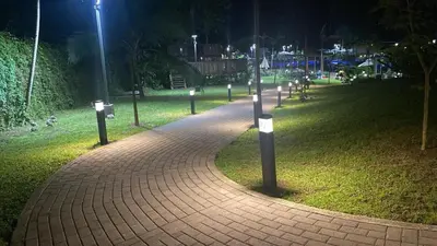 a brick path in a park at night at Casa Coral tu refugio ideal in Herradura