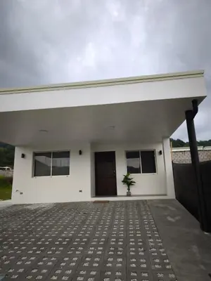a white house with a plant in front of it at Casa Coral tu refugio ideal in Herradura