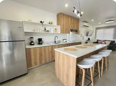 a kitchen with a large island with a counter top at Casa Coral tu refugio ideal in Herradura