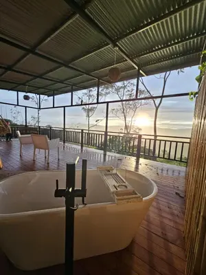 a bath tub in a room with a view of the ocean at VIP Villa Vista Hermosa in San Francisco