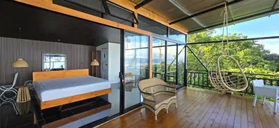 a bedroom with a bed and a balcony with a swing at VIP Villa Vista Hermosa in San Francisco