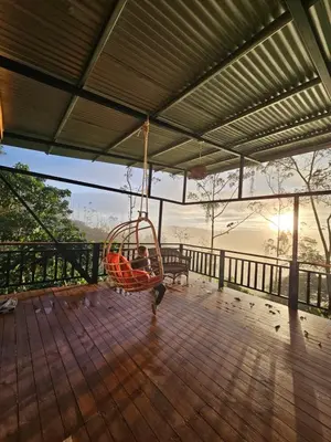 a person is sitting in a swing on a porch at VIP Villa Vista Hermosa in San Francisco