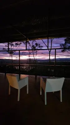 two chairs and a table in front of a sunset at VIP Villa Vista Hermosa in San Francisco