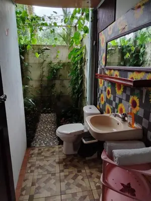 a bathroom with a toilet and a sink at Casa veranera in Sarapiquí