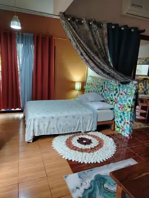 a bedroom with two beds and a rug on the floor at Casa veranera in Sarapiquí