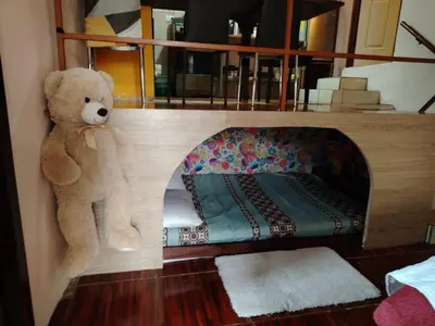 a teddy bear sitting on the corner of a room at Casa veranera in Sarapiquí