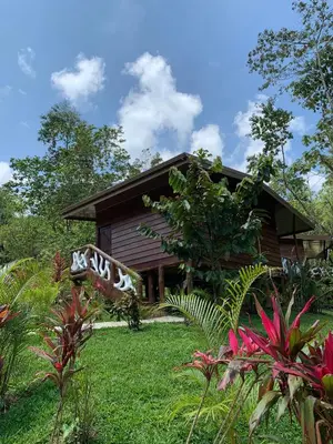 a house with a garden in front of it at Chato Arenal Lodge in Fortuna