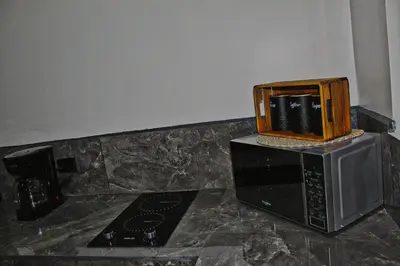 a microwave with a wooden box on top of it at Fortuna Tropical Loft in Fortuna