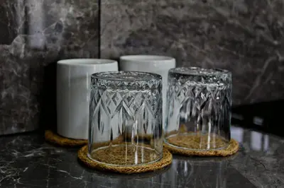 two glass vases sitting on a counter next to cups at Fortuna Tropical Loft in Fortuna