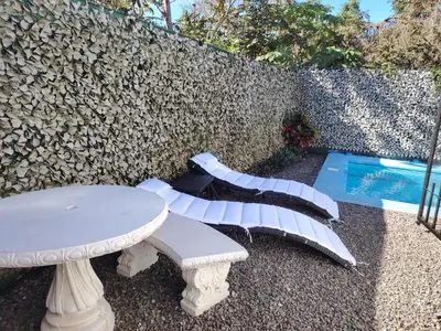a white table and bench next to a swimming pool at Villa Congo 6, Piscina Privada y desconexión, 2km del Peñon de Guacalillo in Tivives