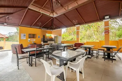 a restaurant with tables and chairs in a room at Villa Congo 6, Piscina Privada y desconexión, 2km del Peñon de Guacalillo in Tivives