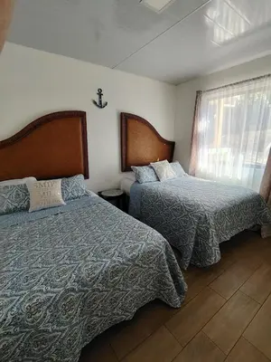 a bedroom with two beds and a window at Villa Congo 6, Piscina Privada y desconexión, 2km del Peñon de Guacalillo in Tivives