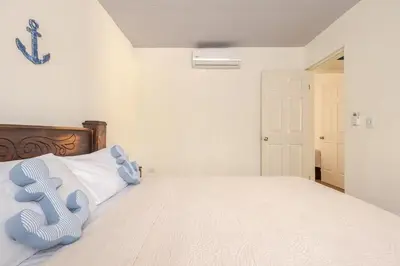 a bedroom with a bed with a blue chair on it at Villa Congo 6, Piscina Privada y desconexión, 2km del Peñon de Guacalillo in Tivives
