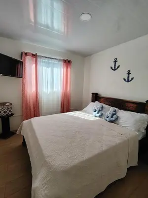 a bedroom with a bed with two stuffed animals on it at Villa Congo 6, Piscina Privada y desconexión, 2km del Peñon de Guacalillo in Tivives