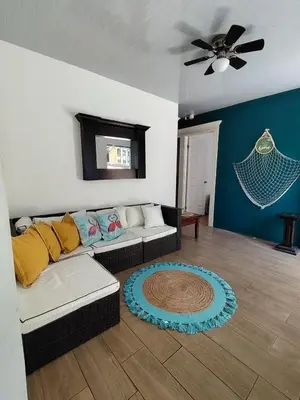 a living room with a couch and a ceiling fan at Villa Congo 6, Piscina Privada y desconexión, 2km del Peñon de Guacalillo in Tivives