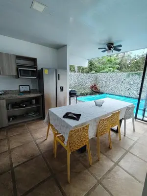 a kitchen and dining room with a table and chairs at Villa Congo 6, Piscina Privada y desconexión, 2km del Peñon de Guacalillo in Tivives