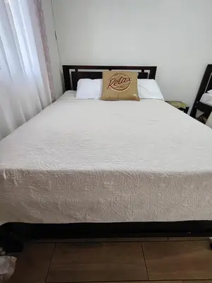 a bed in a bedroom with a white bedspread at Villa Congo 6, Piscina Privada y desconexión, 2km del Peñon de Guacalillo in Tivives