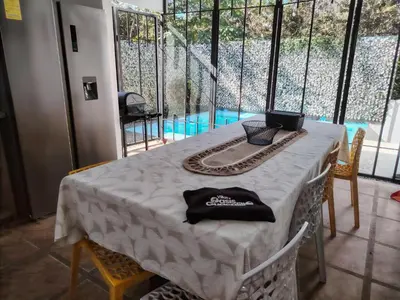 a table with a black hat on top of it at Villa Congo 6, Piscina Privada y desconexión, 2km del Peñon de Guacalillo in Tivives