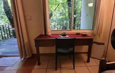 a desk in a room with a window at Nature Lovers Quepos in Quepos