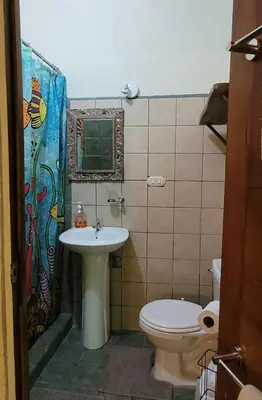 a bathroom with a sink and a toilet at Nature Lovers Quepos in Quepos