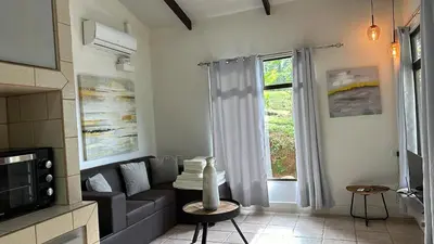 a living room with a couch and a window at Colinas Tinamastes in San Isidro