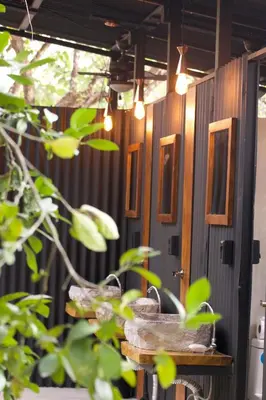 a row of windows on a wall with plants at SurFreak Backyard Glamping CoWorking Experience in Mal País