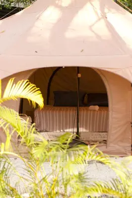 a white tent with a bed in it at SurFreak Backyard Glamping CoWorking Experience in Mal País