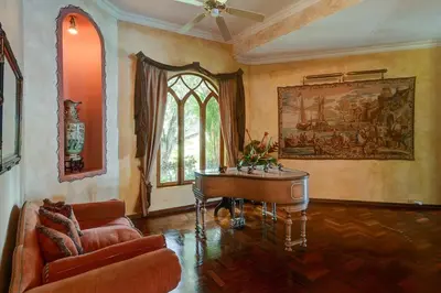 a living room with a piano and a couch at El Castillo de Esparza in Esparza