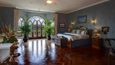 a bedroom with a bed and a large window at El Castillo de Esparza in Esparza