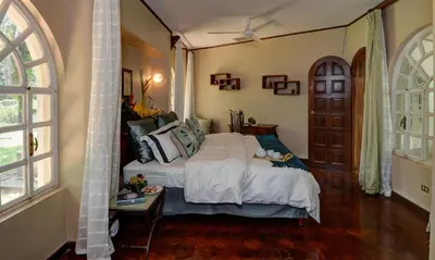 a bedroom with a bed and a table and a window at El Castillo de Esparza in Esparza