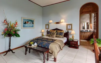 a bedroom with a large bed and a table at El Castillo de Esparza in Esparza