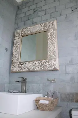 a mirror on a wall above a sink in a bathroom at Nosara Verde in Nicoya
