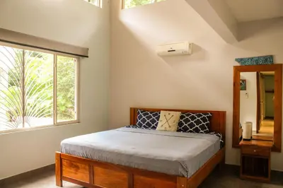 a bedroom with a bed and a window at Nosara Verde in Nicoya