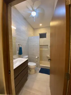 a bathroom with a toilet and a ceiling fan at Casa Las Olas in Esterillos