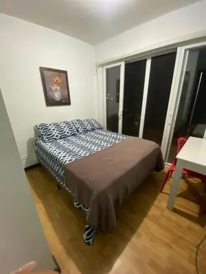a bedroom with a bed in a room with a window at Brisa del Río Santa Ana in Río Oro