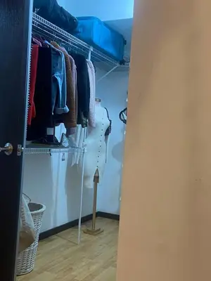 a closet with a rack of clothes in it at Brisa del Río Santa Ana in Río Oro