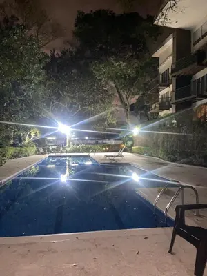 a swimming pool at night with lights at Brisa del Río Santa Ana in Río Oro