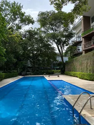 a large blue swimming pool next to a building at Brisa del Río Santa Ana in Río Oro
