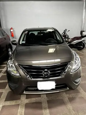 a silver car parked in a garage with a motorcycle at Yireth Studio in Quepos