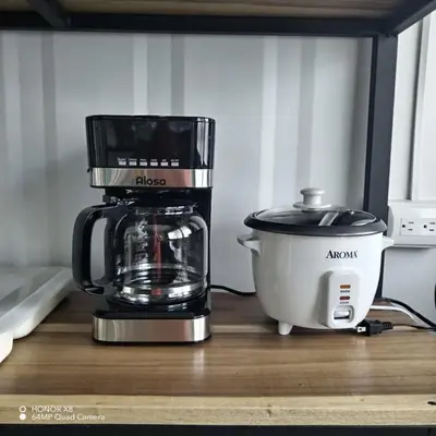 a coffee maker sitting on a counter next to a coffee pot at Elegant studio in Fortuna