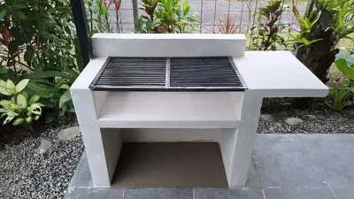 a white bench sitting on a sidewalk in a garden at Elegant studio in Fortuna
