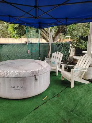 a patio with two chairs and an umbrella and a table at Villa jr 1 Private Jacuzzi near peñon guacalillo in Tivives