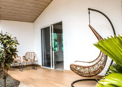 a swing in the living room of a house at Oshy Sunset Apartments - 10 mins from Tamarindo in Villarreal