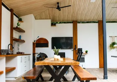 a dining room with a wooden table and chairs at Oshy Sunset Apartments - 10 mins from Tamarindo in Villarreal