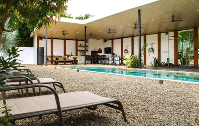 a house with a swimming pool in the middle at Oshy Sunset Apartments - 10 mins from Tamarindo in Villarreal